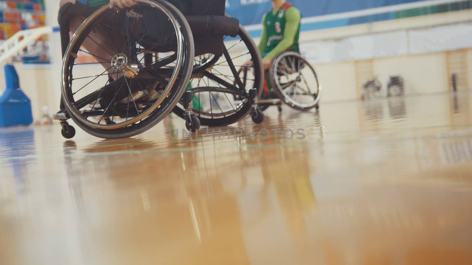 Handicapped basketball player in a wheelchair during sportive training, close up