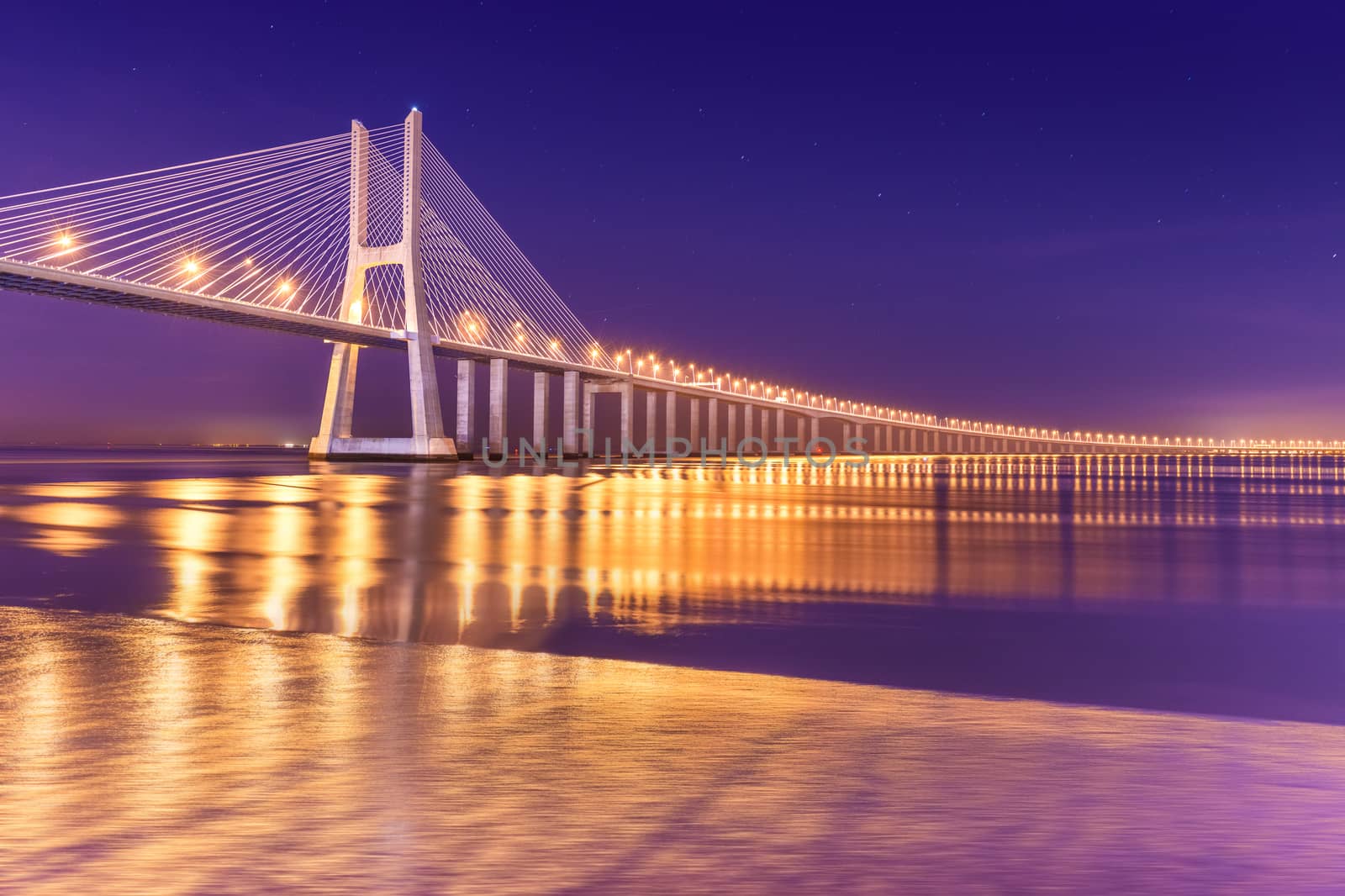 View of a modern cable-stayed bridge at night (Vasco da Gama Bridge), Lisbon, Portugal