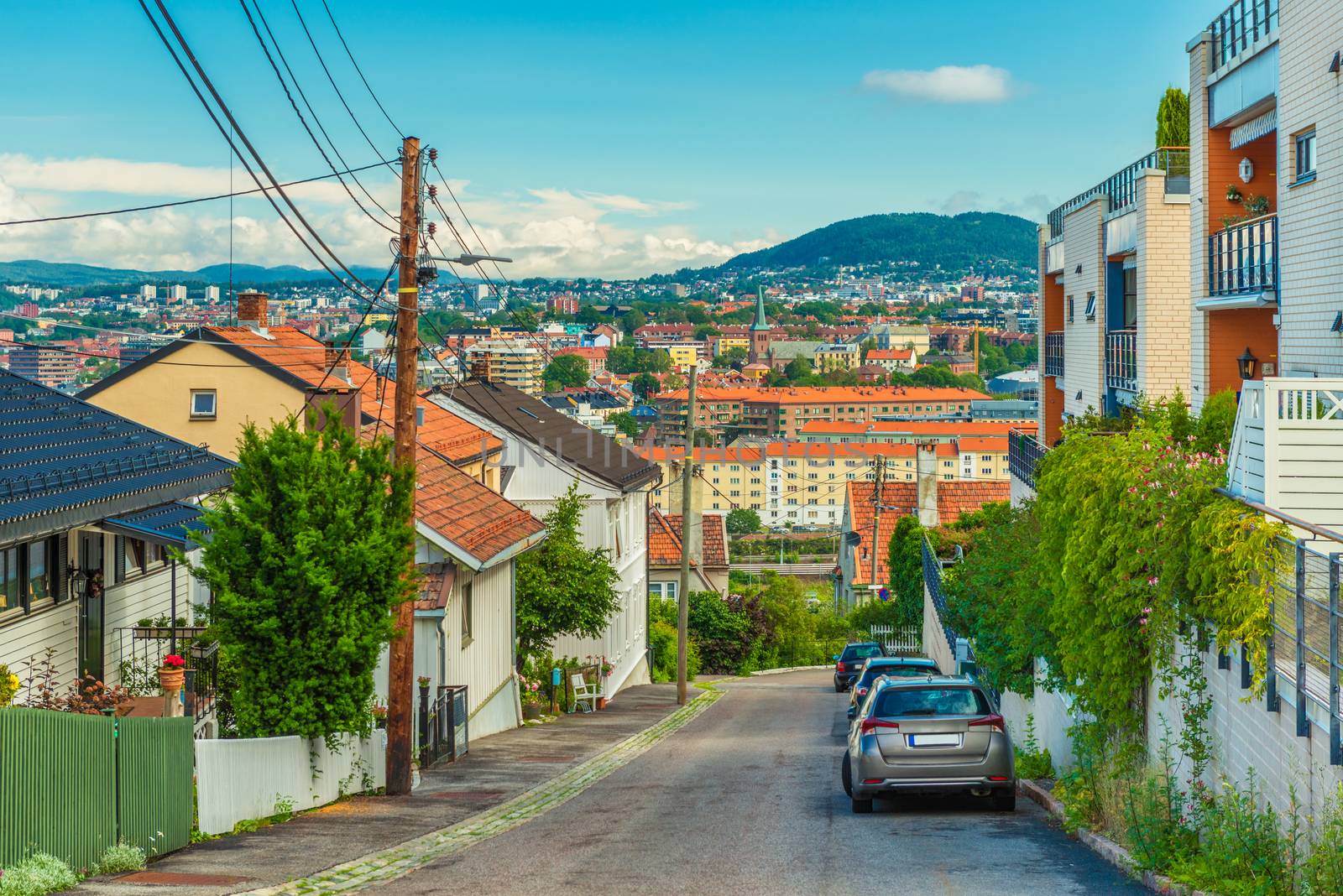 A street in Oslo, Norway. Beautiful view from a hill with old wooden houses to the city center with colorful architecture