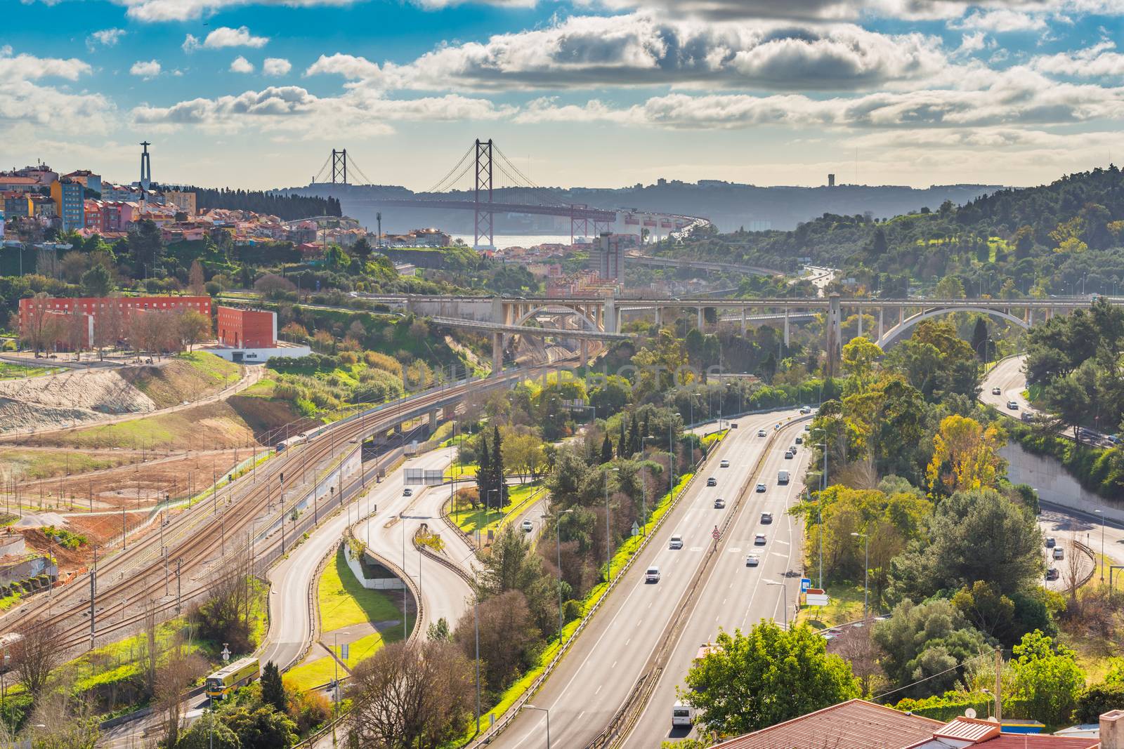 Aerial panorama of Lisbon with highways, overpasses and The 25th April Bridge (Ponte 25 de Abril), Portugal
