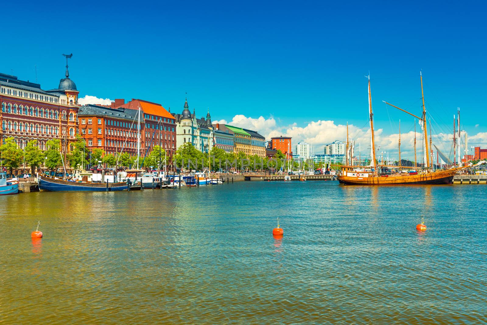 Beautiful cityscape of Helsinki, Finland. Old historical buildings, wooden ship, blue sky with clouds