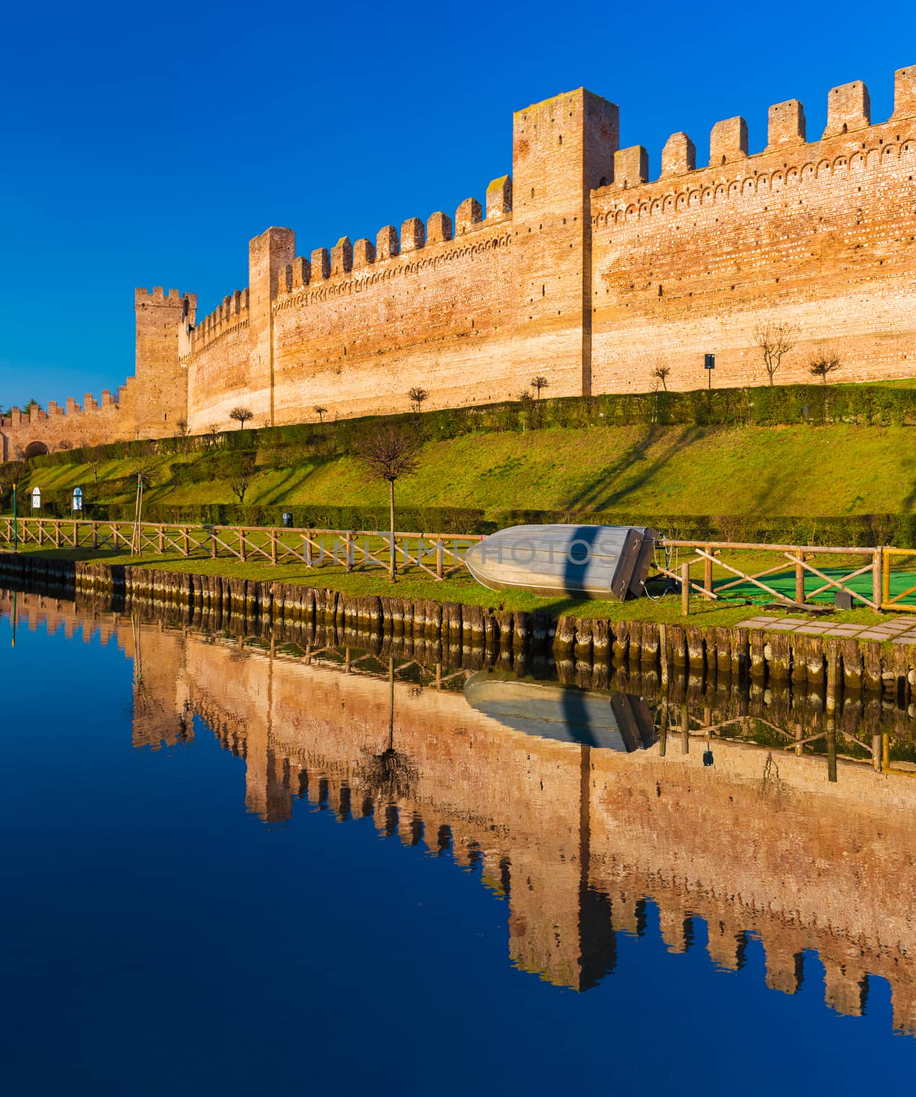 Walled city of Cittadella, brick wall mirror reflected in the water, province of Padua, Italy