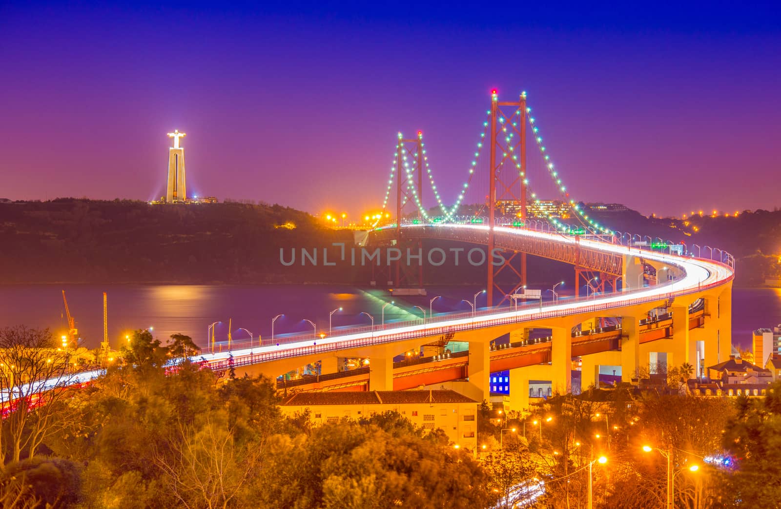 The 25th April Bridge (Ponte 25 de Abril) at night. Lisbon, Portugal.