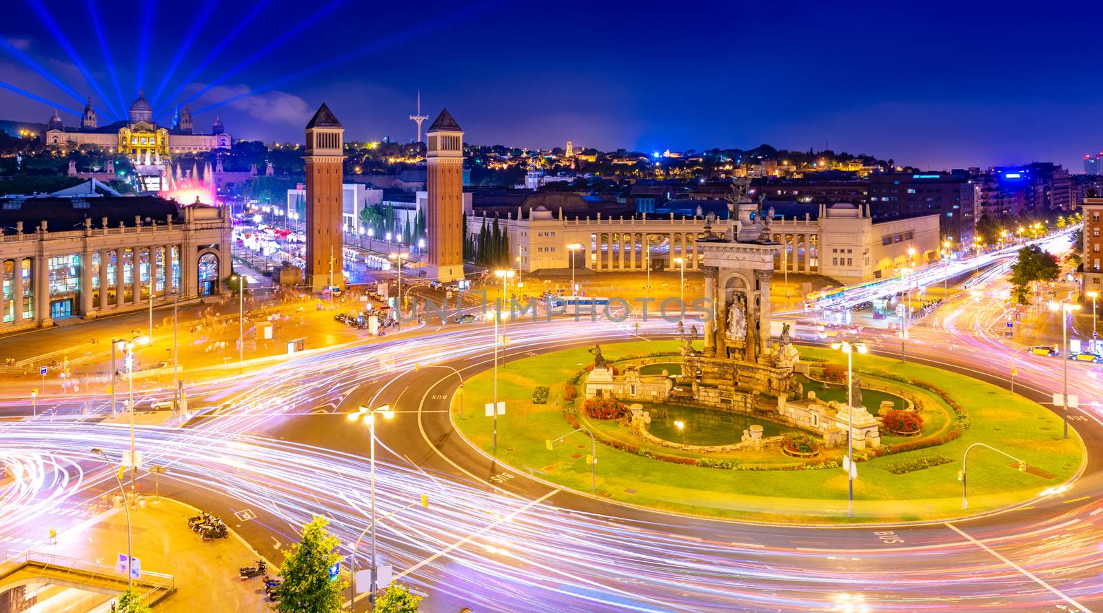 Night view of Barcelona from the trade center Arenas de Barcelona. The central square (Plaça d'Espanya) with numerous traffic light trails and historical architecture, Spain
