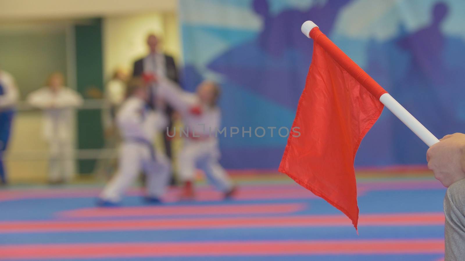 Red flag in front of teenager girls fighting at the karate tournament by Studia72