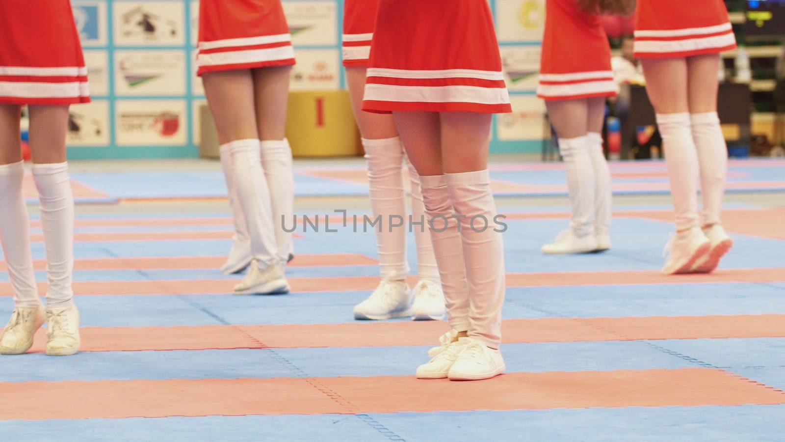 Legs of dancing cheerleaders at the karate tornament, close up