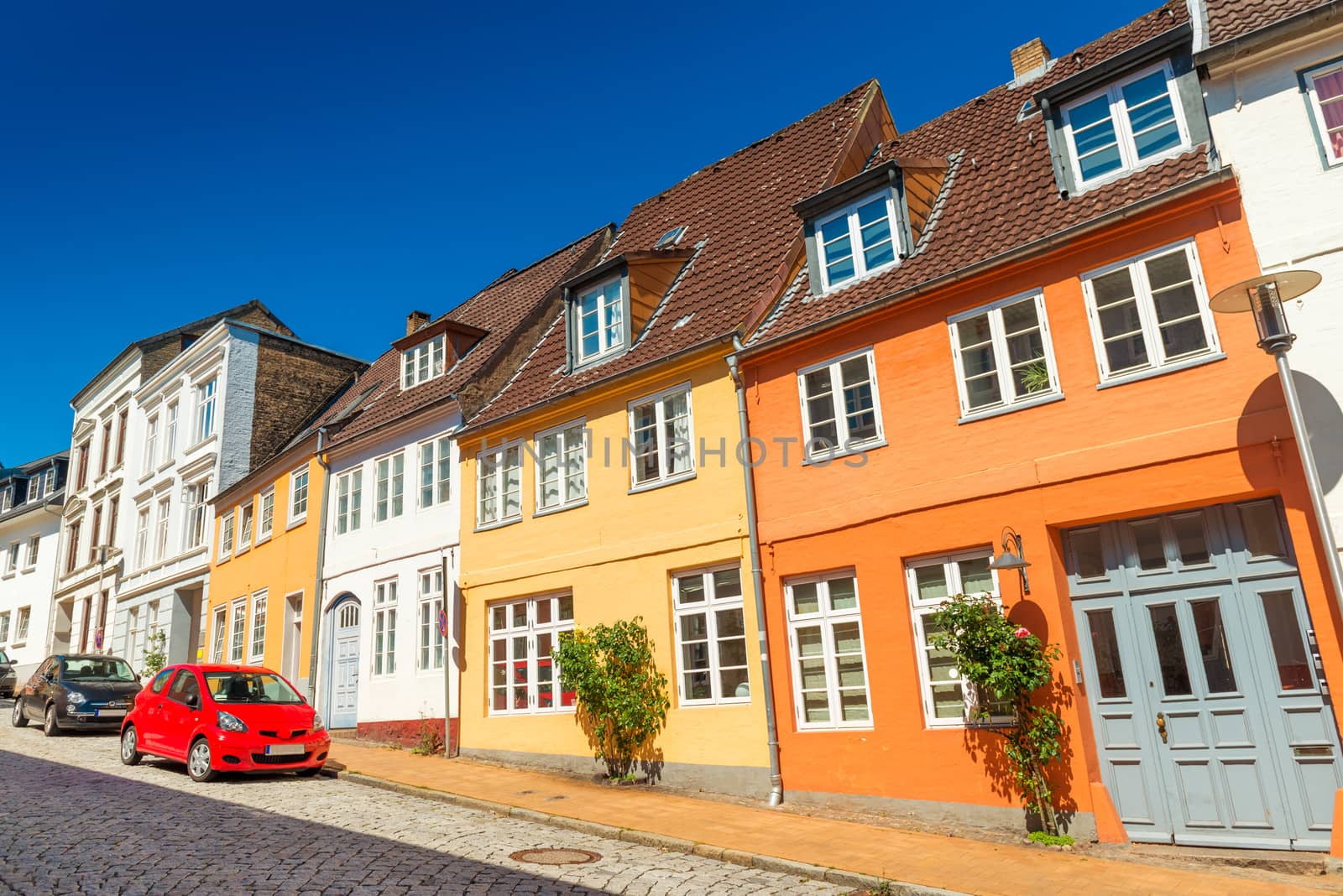 Empty street of a small European town. Colored historical houses in the traditional german-danish style. Flensburg, Germany