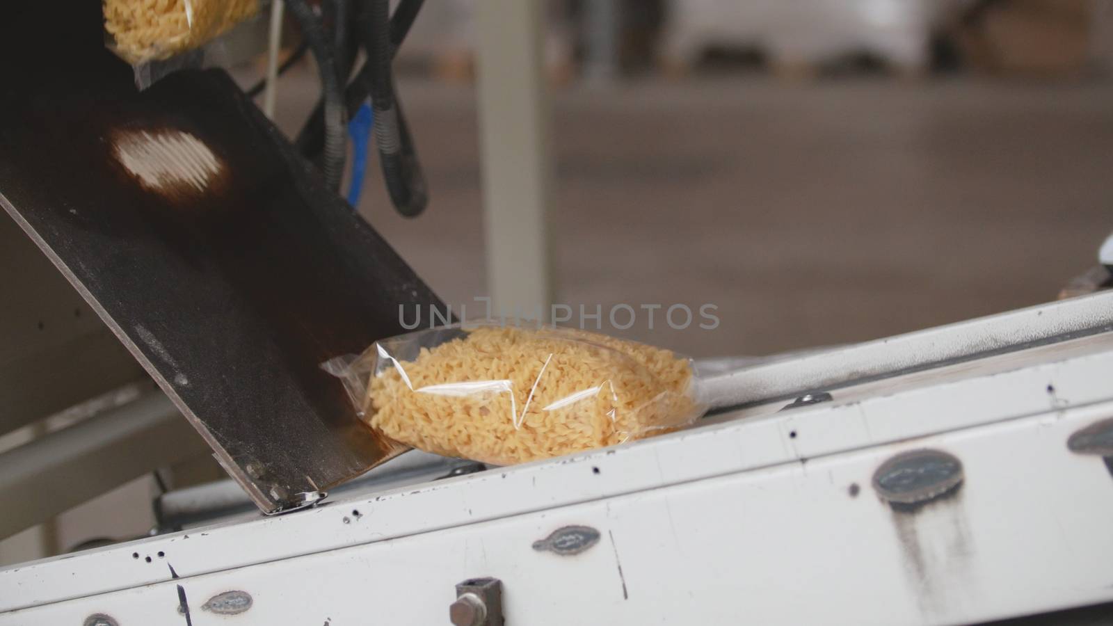 Packed macaroni on a production line in a pasta manufactury by Studia72