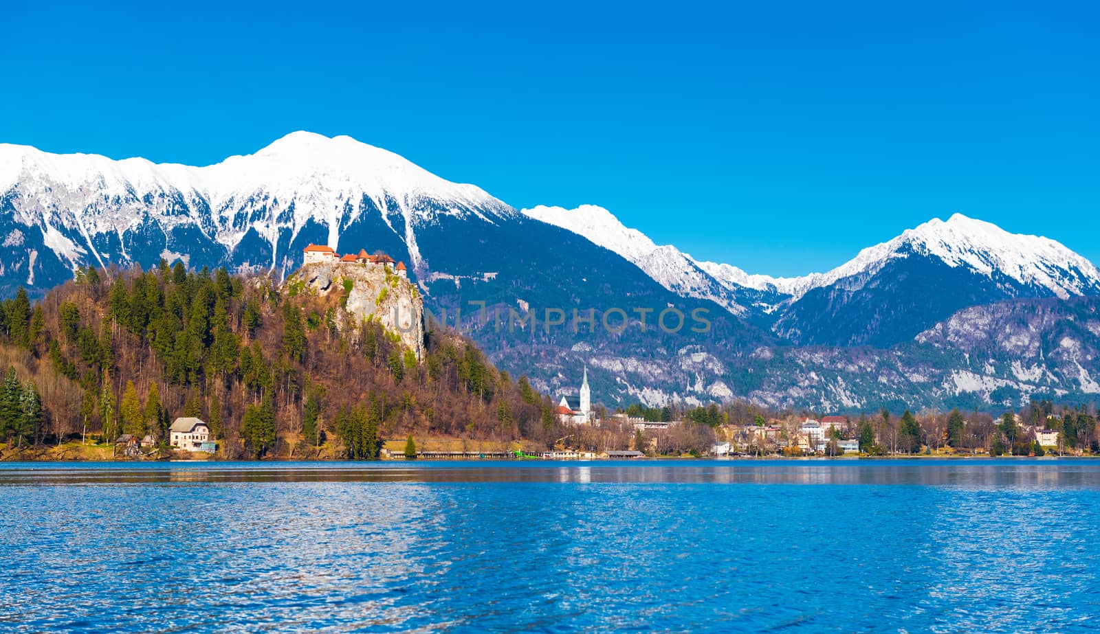 Lake Bled in Slovenia. Snowy mountains with clear blue sky on the background