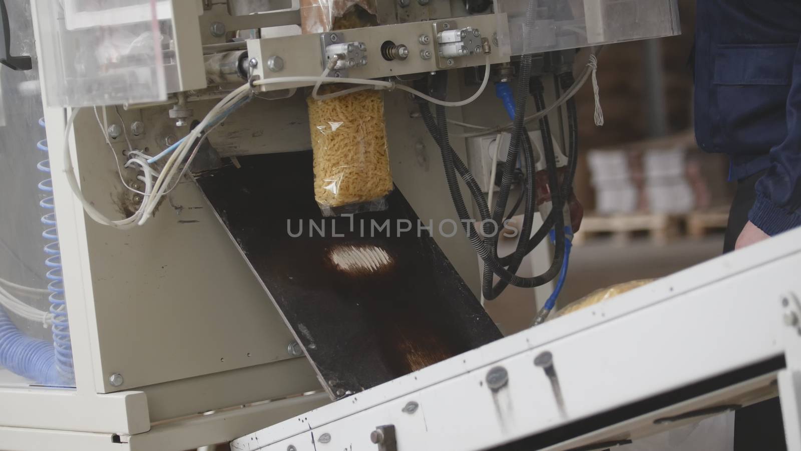 Food manufacturing - packing of macaroni in plastic bags, telephoto