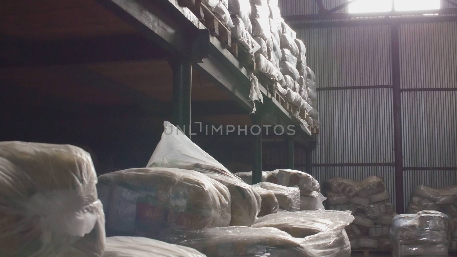 Shelves of cardboard boxes inside a storage food warehouse, wide angle