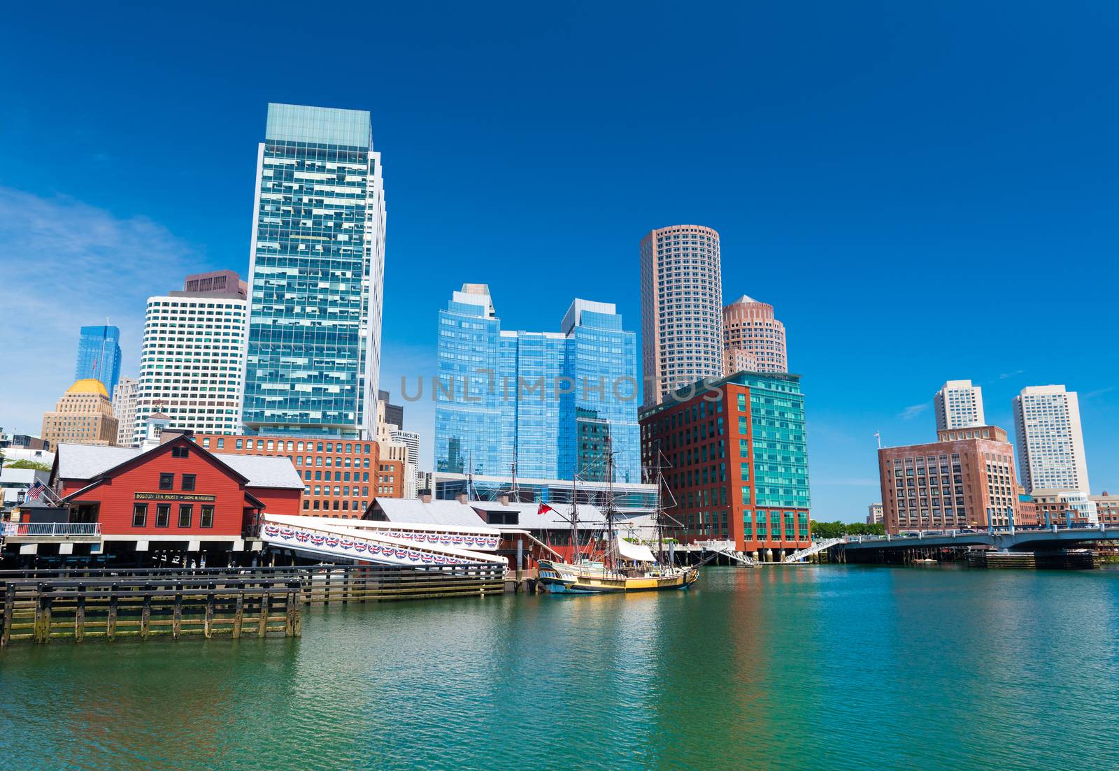 Boston - June 2016, MA, USA: Boston cityscape, Tea Party museum and modern buildings in downtown reflected in water