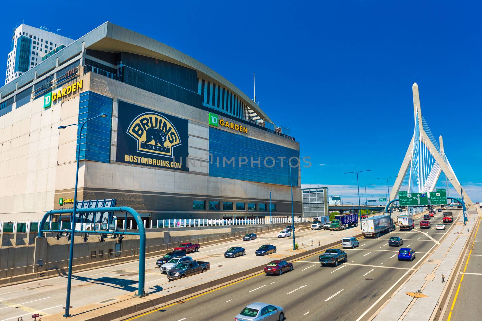 Boston - June 2016, MA, USA: View of TD Garden, Leonard P. Zakim Bunker Hill Bridge and highway with traffic in sunny summer day with clear blue sky