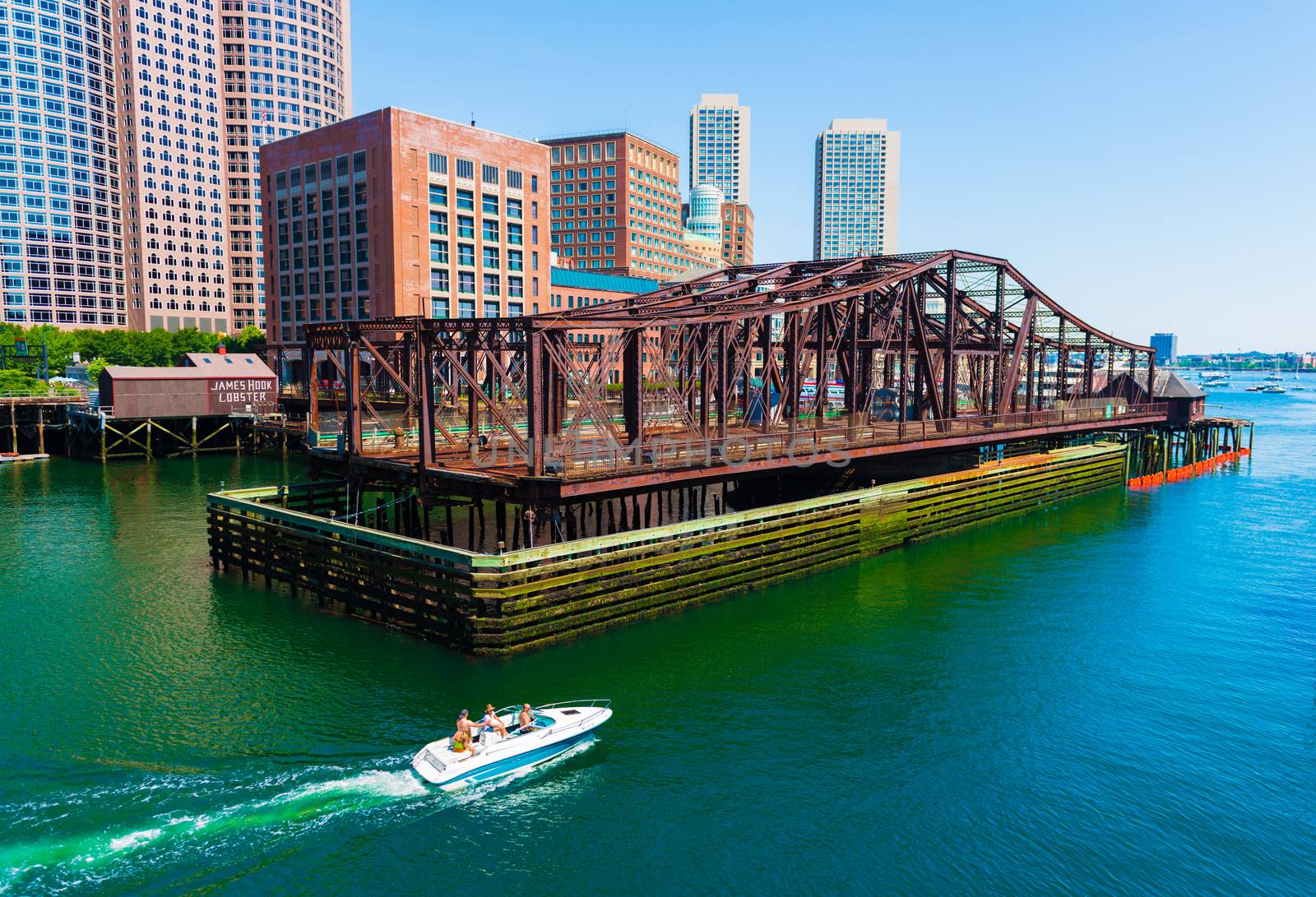 Boston - June 2016, MA, USA: Boat with people is floating on water from Boston harbor towards the open sea (ocean)