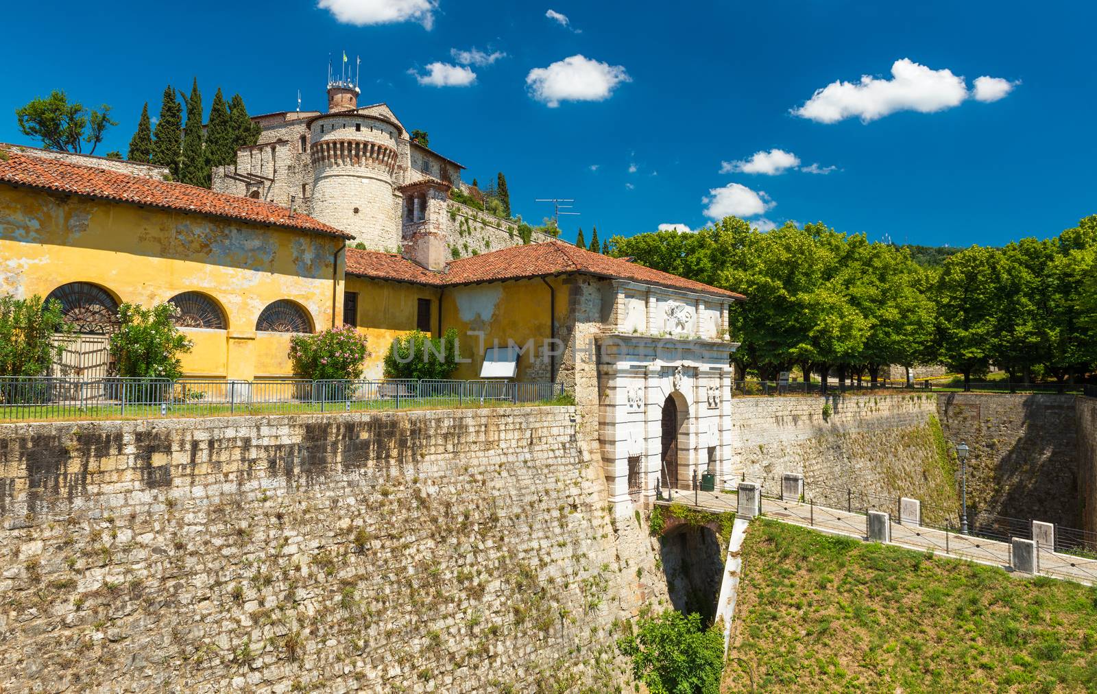 Brescia - July 2017, Lombardy, Italy: The Castle of Brescia and city gates with bridge