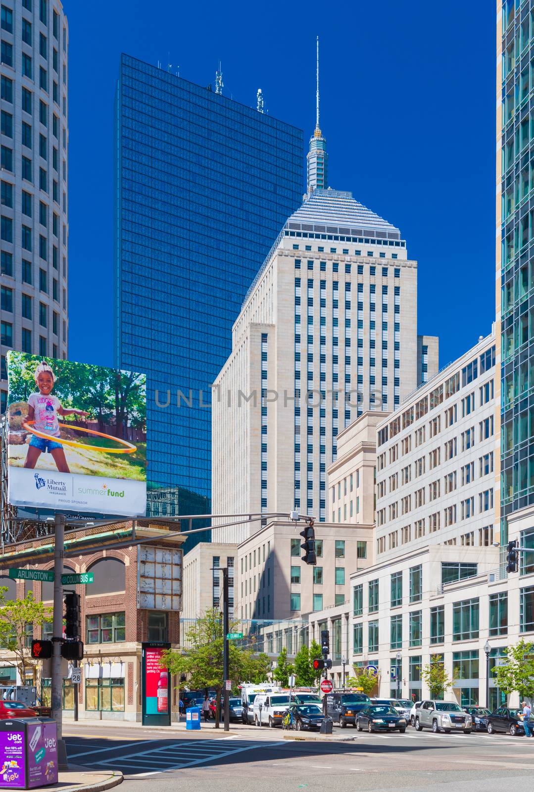 Boston - June 2016, USA: The street of Boston, view of John Hancock Tower, Berkeley Building and surrounding buildings in Back bay district, cars on intersection