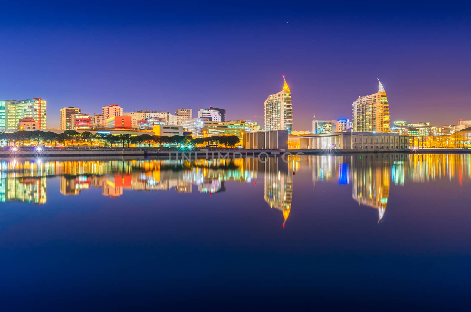 Lisbon - February 2019, Portugal: Night view of The Nations Park (Parque das Nações) in Lisbon. Modern buildings mirrored in the water