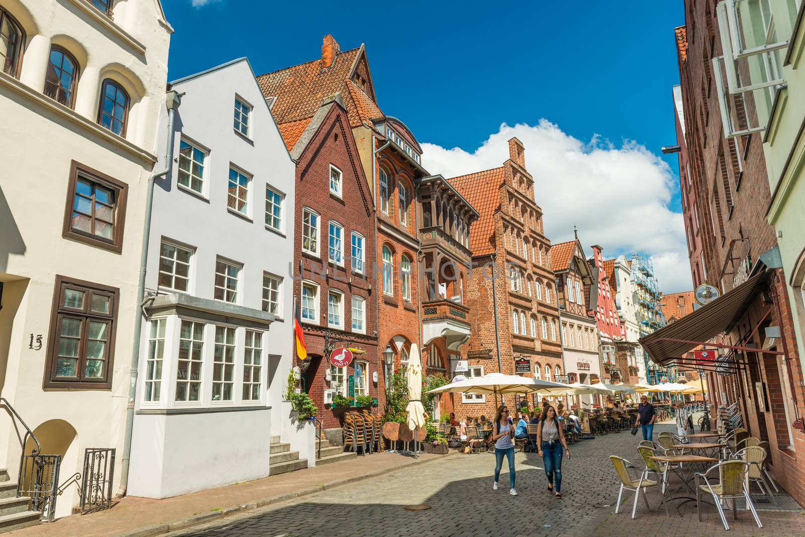 Luneburg (Lüneburg) - July 2018, Germany: Old historical houses in one of the streets of the famous German town. Traditional architecture style, brick and painted buildings with triangle roofs