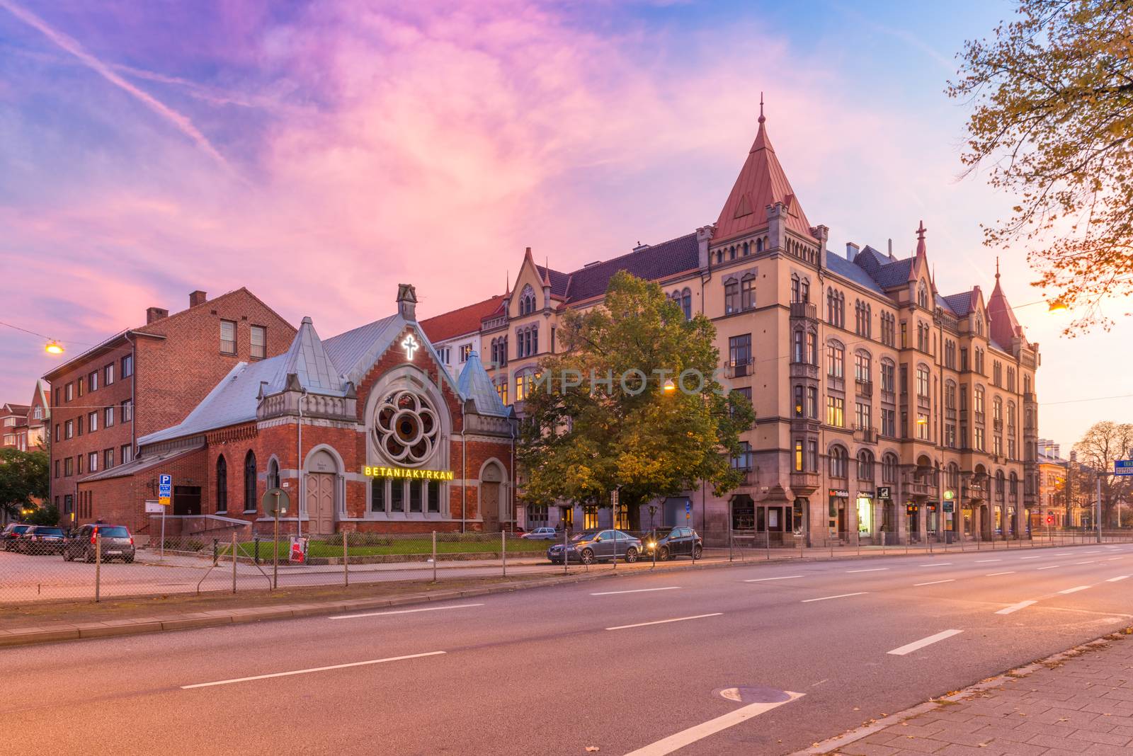 Malmo - October 2018, Sweden: Beautiful sunset in Malmö. View of Betaniakyrkan (Church), old historical buildings and a road with no traffic