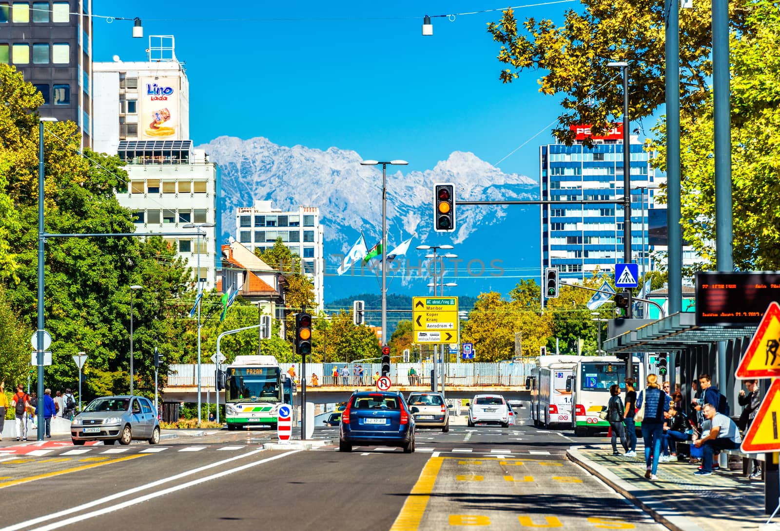 Ljubljana - September 2019, Slovenia: View of the main street with car traffic and beautiful snowy Alps in the background
