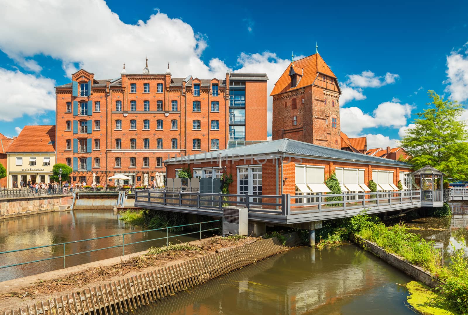 Luneburg - July 2018, Lower Saxony, Germany: Historical buildings and modern restaurant build on the water