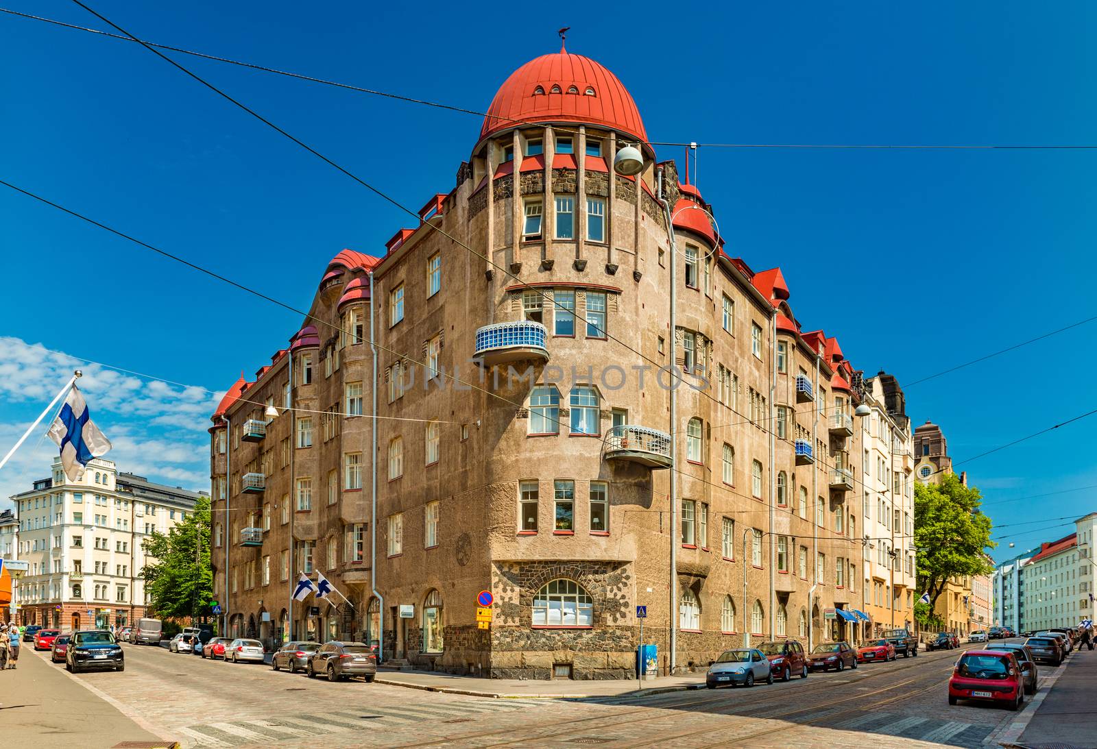 Helsinki - June 2019, Finland: A building in the historical part of Helsinki. View of a street with parked cars and an old building