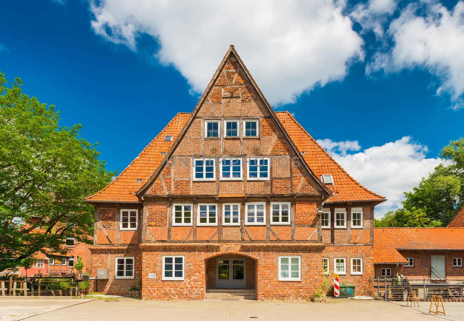 Luneburg - July 2018, Germany: Old brick half-timbered house in the traditional German architecture style. Facade of a historical building in a small European town