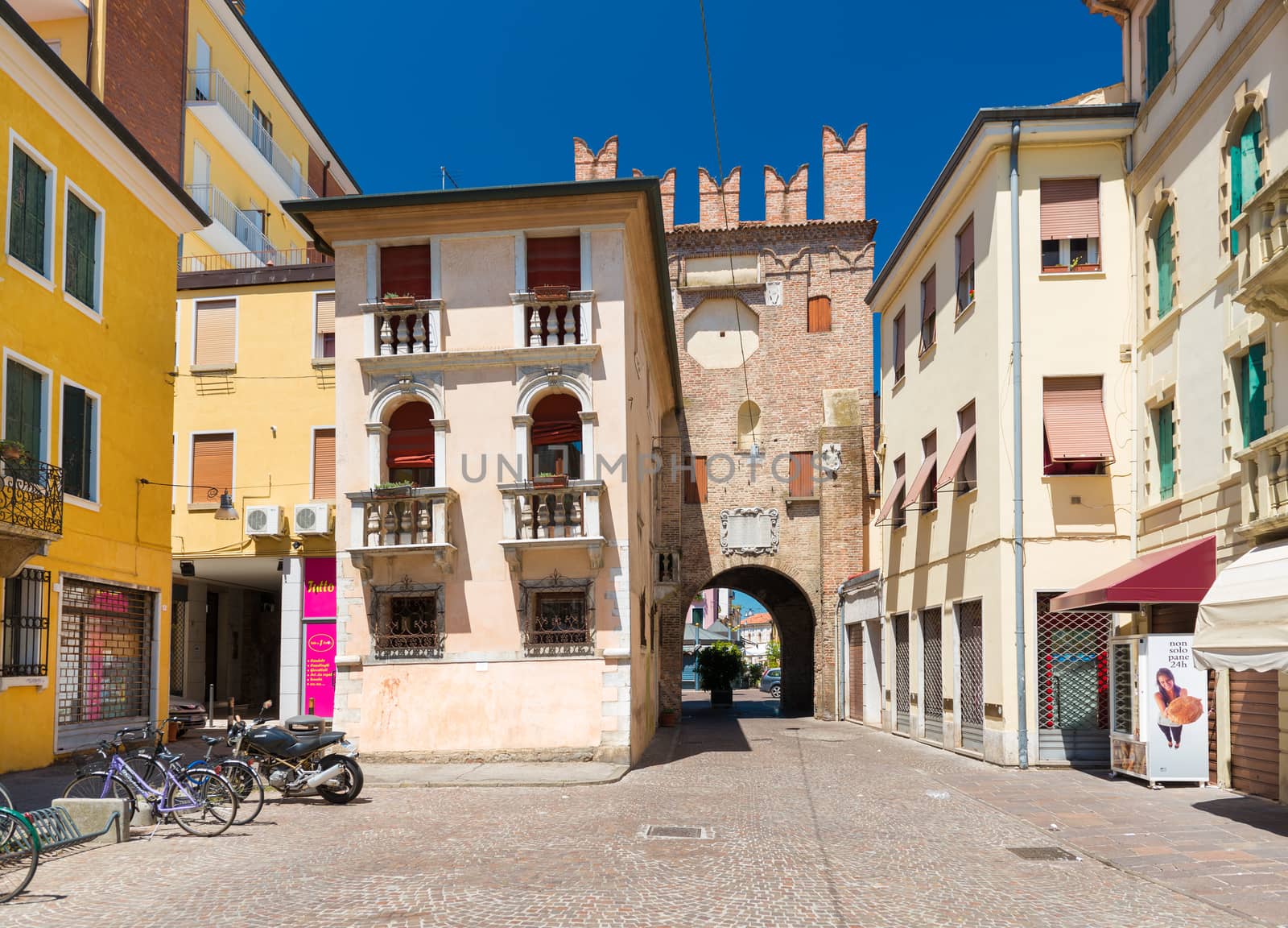 Rovigo - July 2017, Italy: Residential houses and the old tower made of red brick, historic center of Rovigo