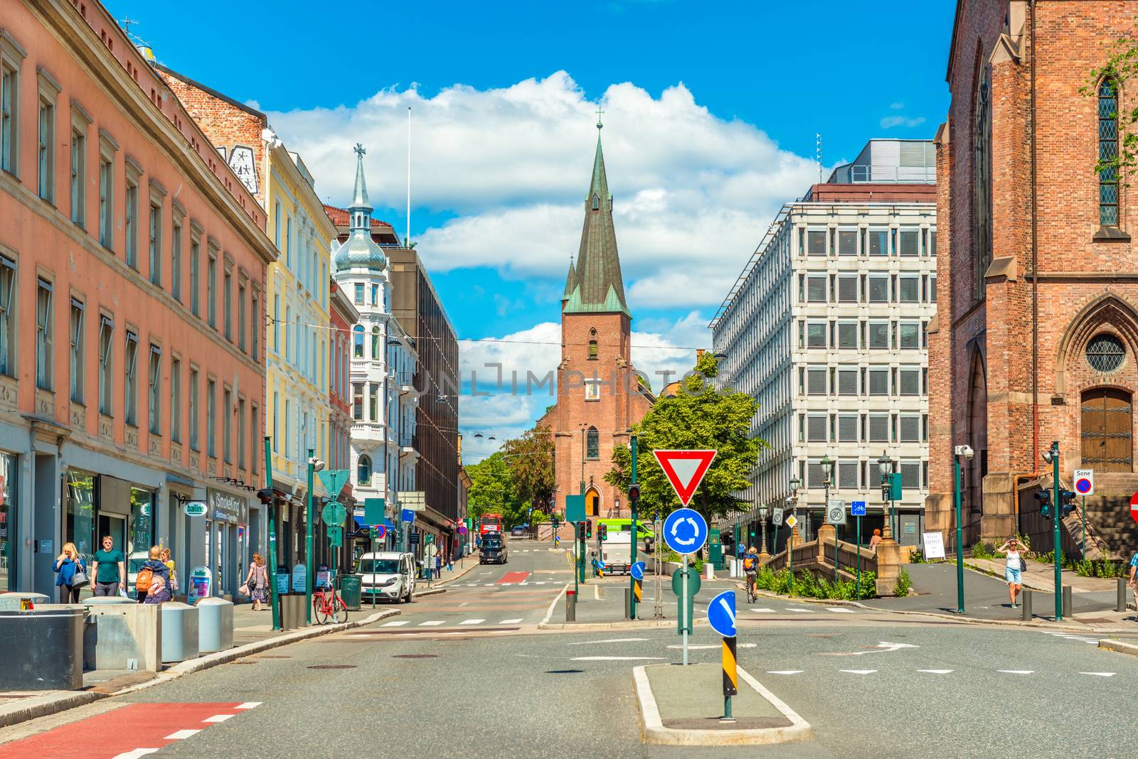 Oslo - June 2019, Norway: View of St. Olav's Cathedral in the center of Oslo. A street with historical architecture and walking people