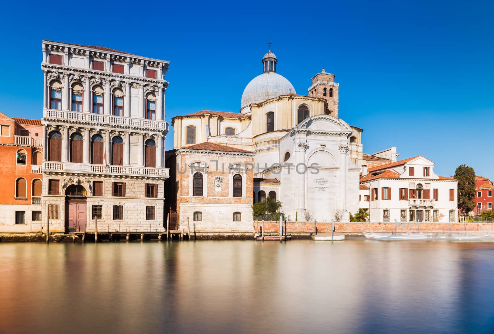 Venice - January 2017, Veneto, Italy: The street of Venice, old houses and San Geremia church (Chiesa di San Geremia e Lucia) reflected in the water of Grand Canal, famous landmark in the city