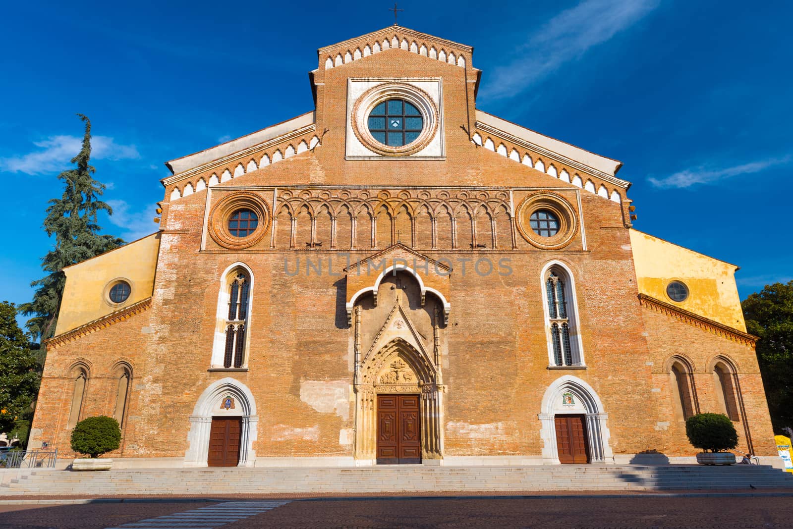 Udine - February 2017, Friuli Venezia Giulia, Italy: Roman Catholic cathedral in Udine (Duomo di Santa Maria Annunziata), wide angle view, sunny day with a blue sky