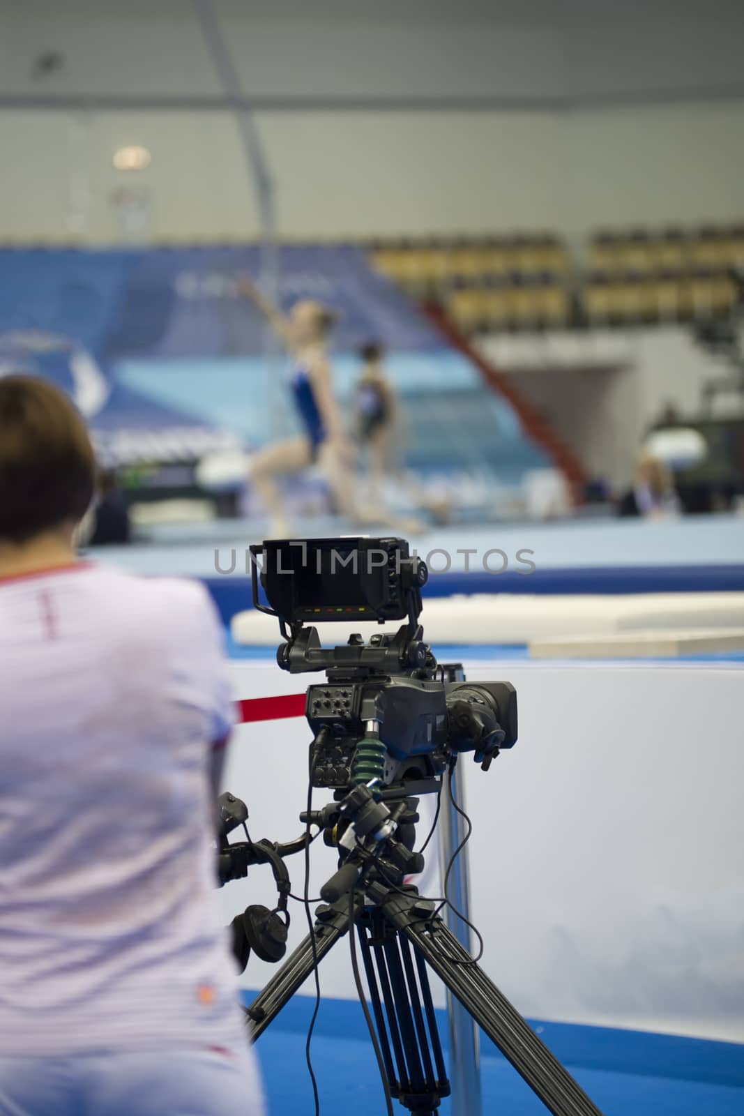 Female athlete gymnasts performing in front of camera in stadium , close up, blurred