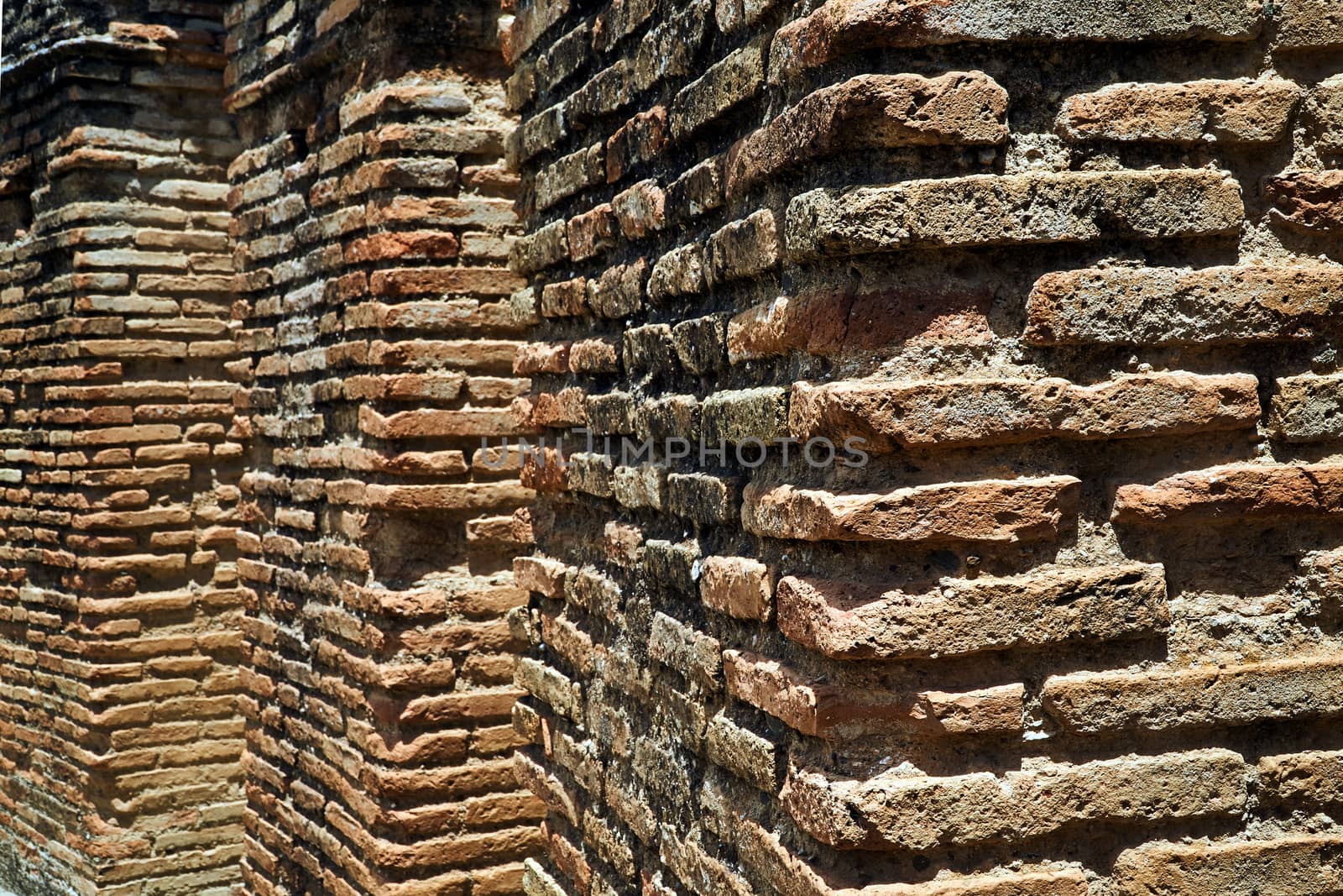 A fragment of a brick wall in the ruins of  the ancient Roman city of Gortyna on the island of Crete in Greece