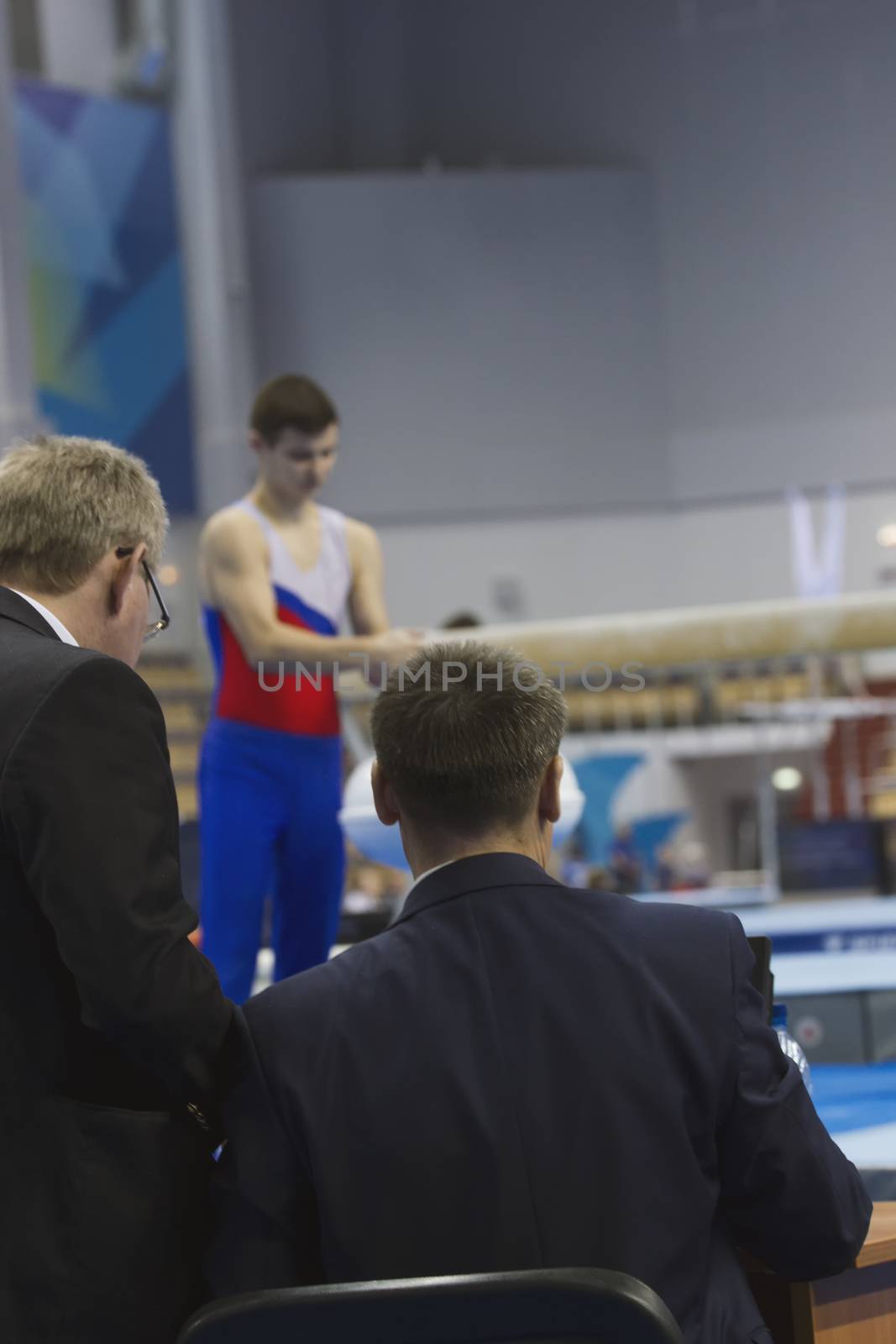 Young man gymnasts preparing in front of judge at the competition by Studia72