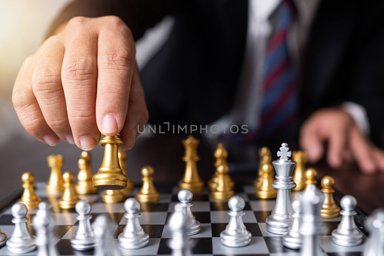 Planning and strategy of successful business competition management concept, businessman moves king of chess