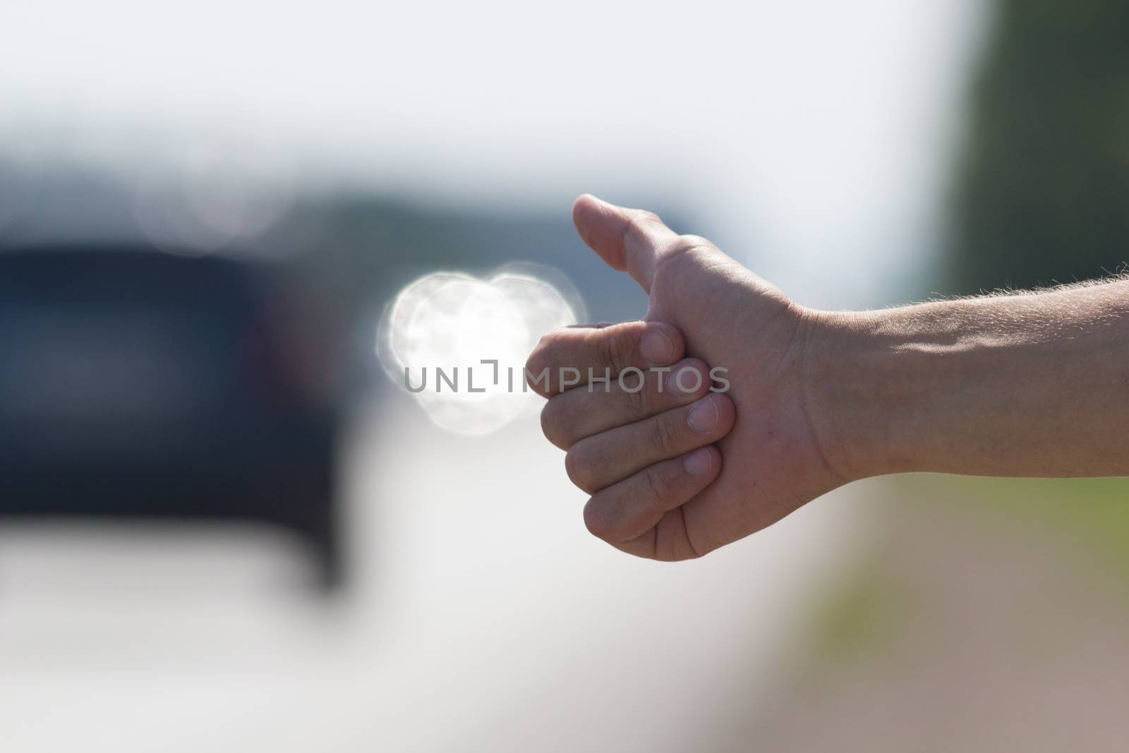 Hand of a man who honks to passing cars, hitchhiking trip by Studia72