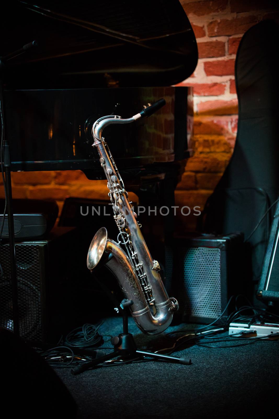 Beautiful saxophone stands on the stand on stage in jazz bar, close up