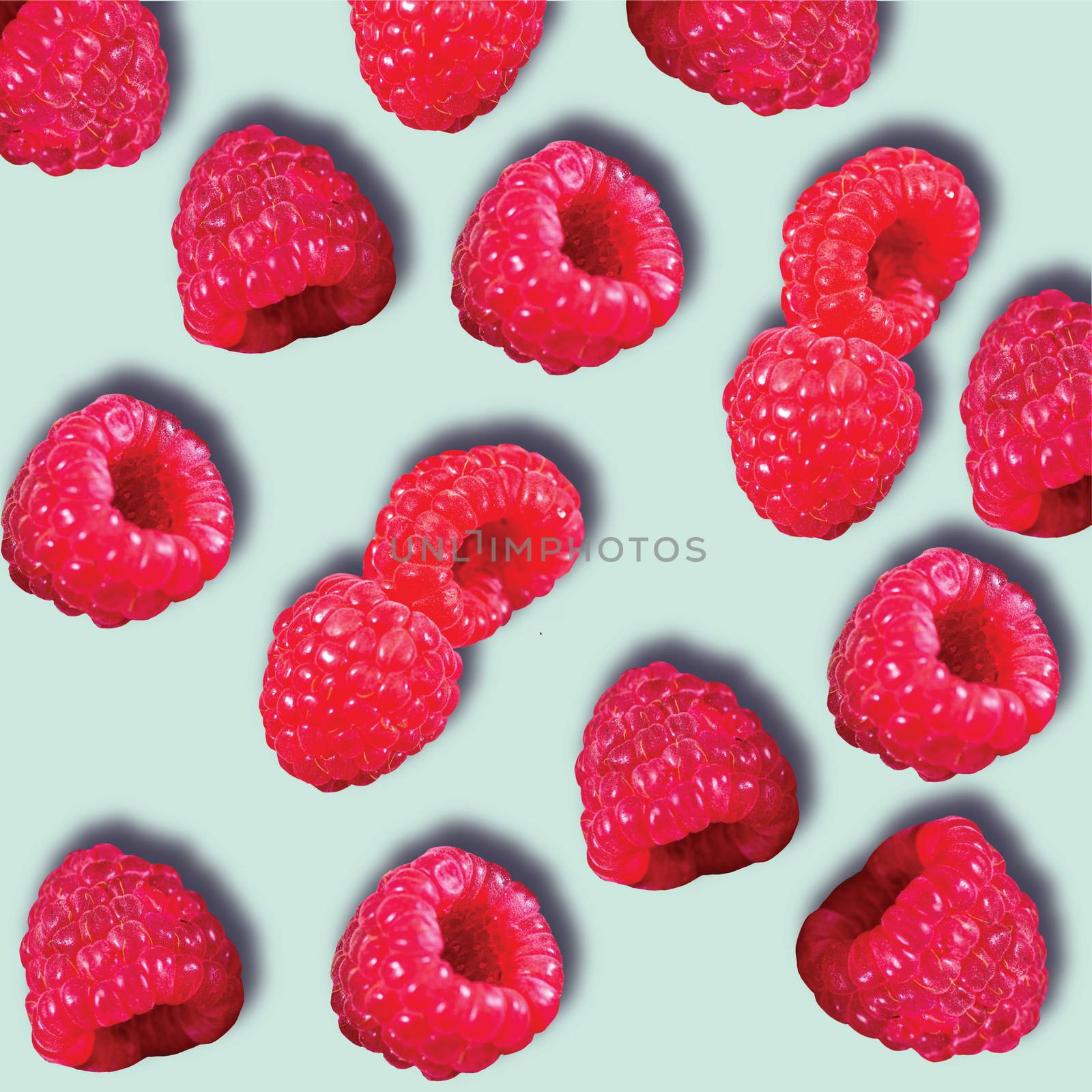 Pattern of Raspberries sweet organic juicy berries on blue background. Flat lay, top view.