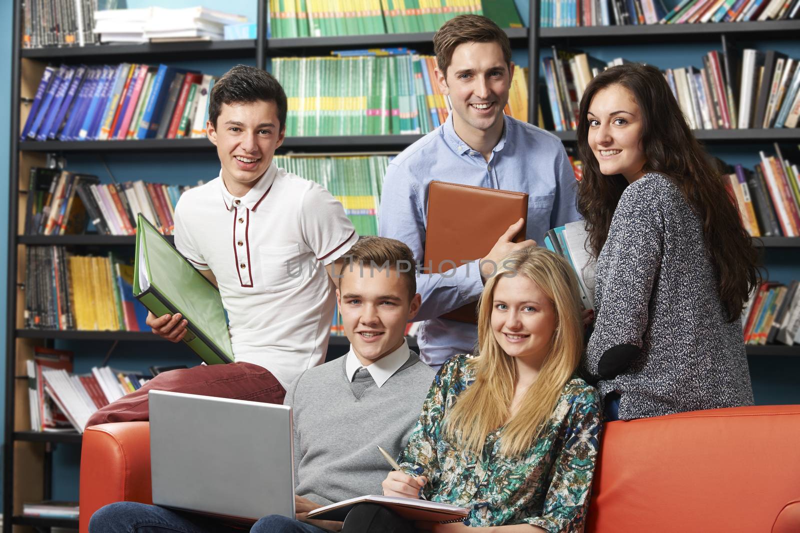 Portrait Of Teacher With Students In Library