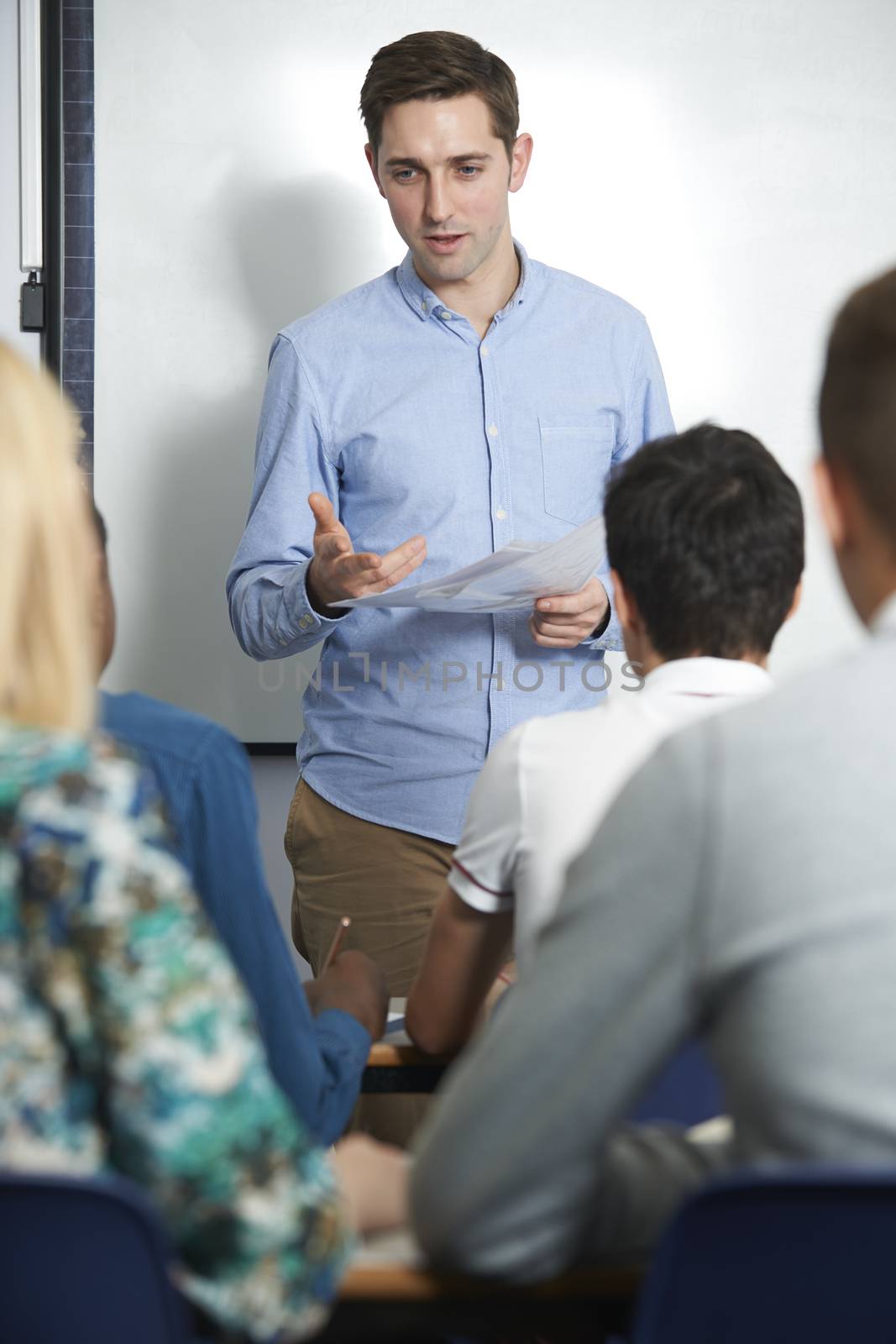 Teacher Talking To Pupils In Class by HWS