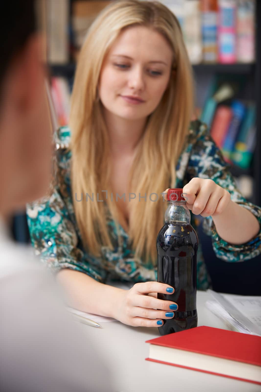 Teeange Female Student With Bottle Of Fizzy Drink In Class by HWS