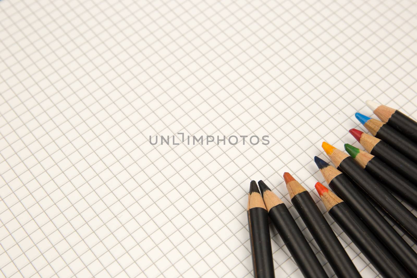 Colored pencils and squared paper, return to the old ways of drawing and coloring concept by robbyfontanesi