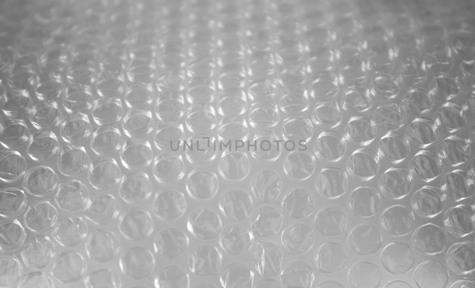 Bubble wrap sheet shot in selective focus with light effect by robbyfontanesi