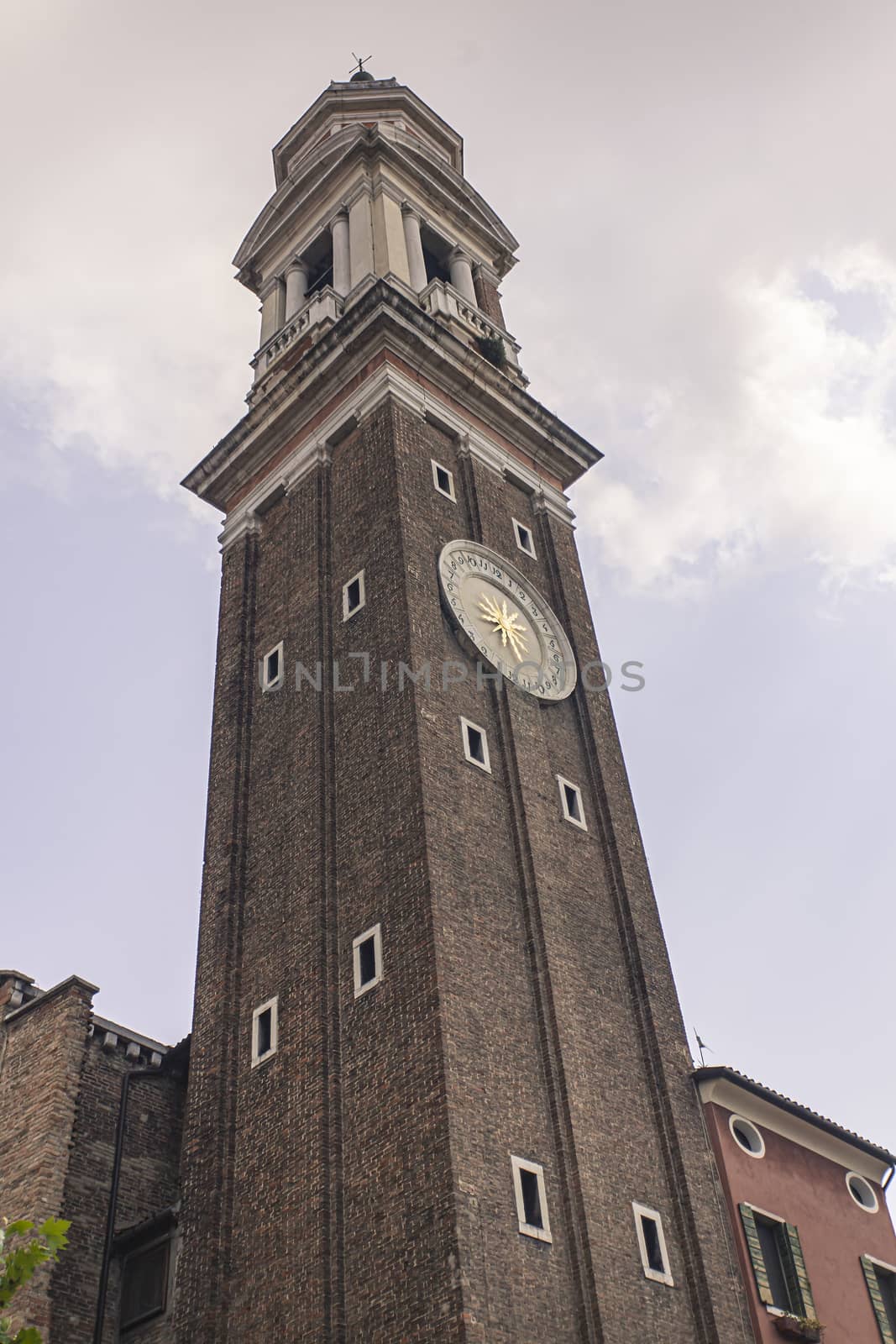 Deatil of Santi Apostoli bell tower in Venice in Italy
