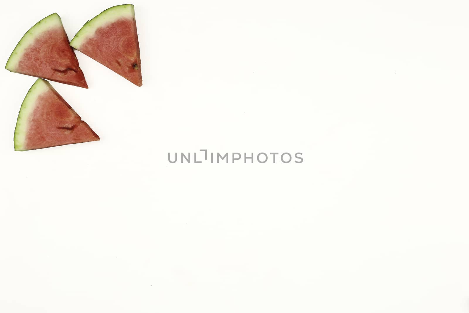 Triangular isolated slices of watermelon forming geometric games for copy space on a white background by robbyfontanesi