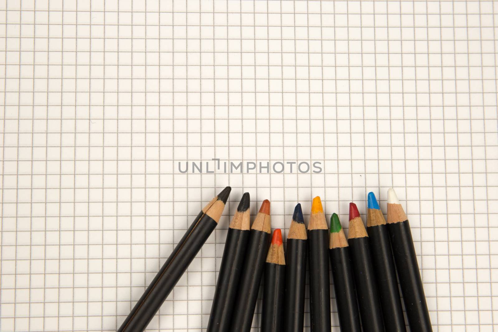 Colored pencils and squared paper, return to the old ways of drawing and coloring concept by robbyfontanesi