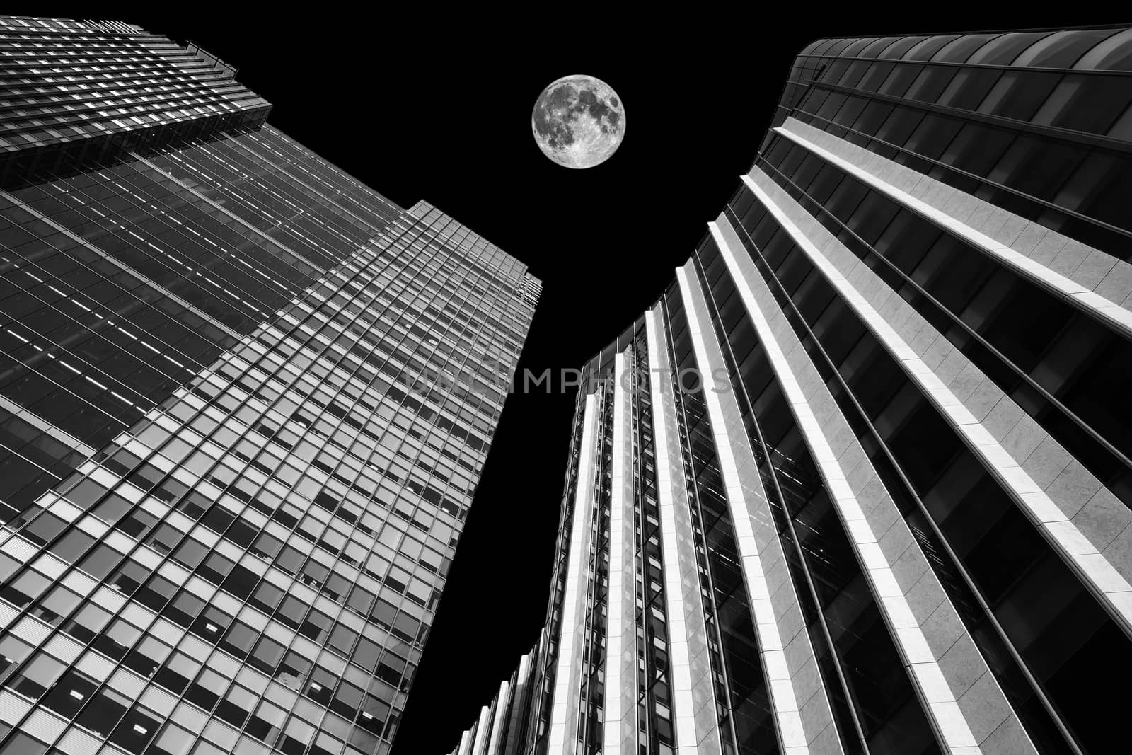 skyscraper buildings architecture at night with a full moon by ant