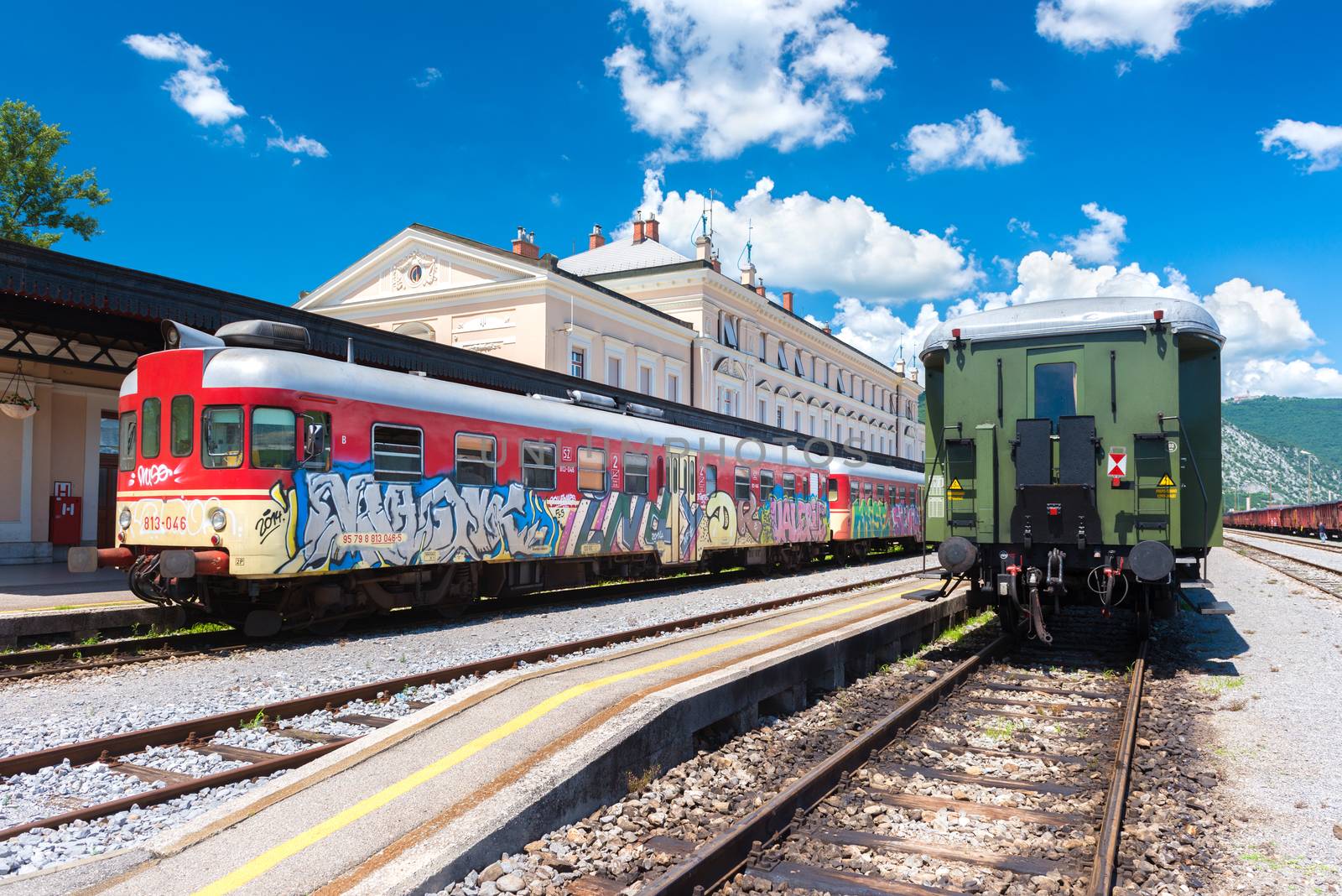 Nova Gorica (Gorizia) - June 2016, Slovenia: View of two trains standing on rails at the old train station in sunny summer day, wide angle perspective