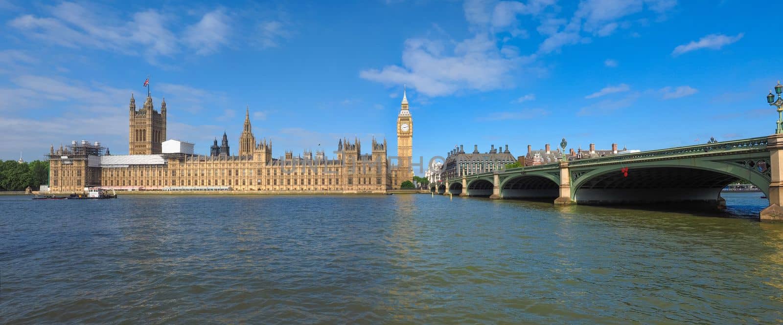 Houses of Parliament aka Westminster Palace and Westminster Bridge seen from River Thames in London, UK