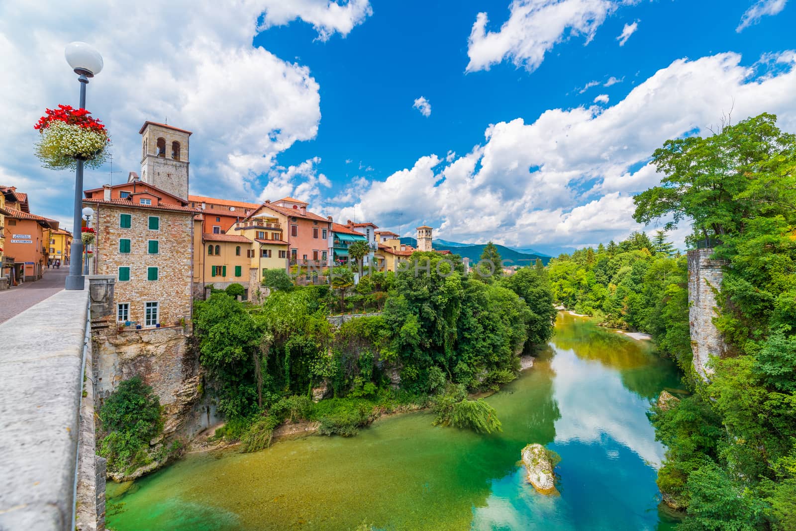 Cividale del Friuli - June 2017, province of Udine, Italy: View of the old city center with traditional architecture. River Natisone with transparent water. Summer day and blue sky with clouds.